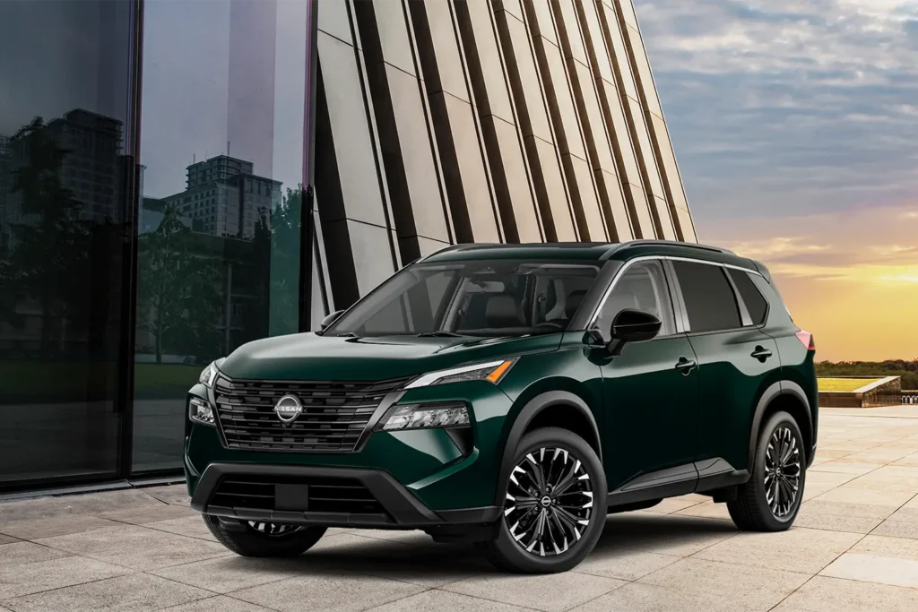 2026 Nissan Rogue compact SUV parked outdoors, showcasing modern design and bold front grille.