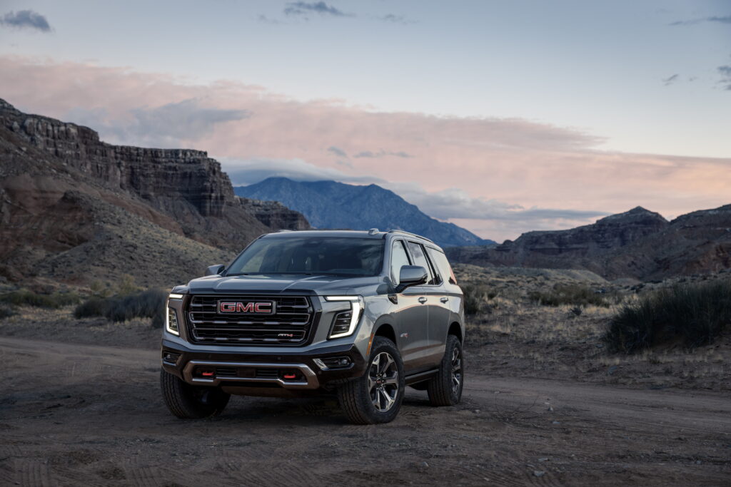 GMC Yukon AT4 parked on a desert trail at dusk, featured in our GMC Yukon Review.