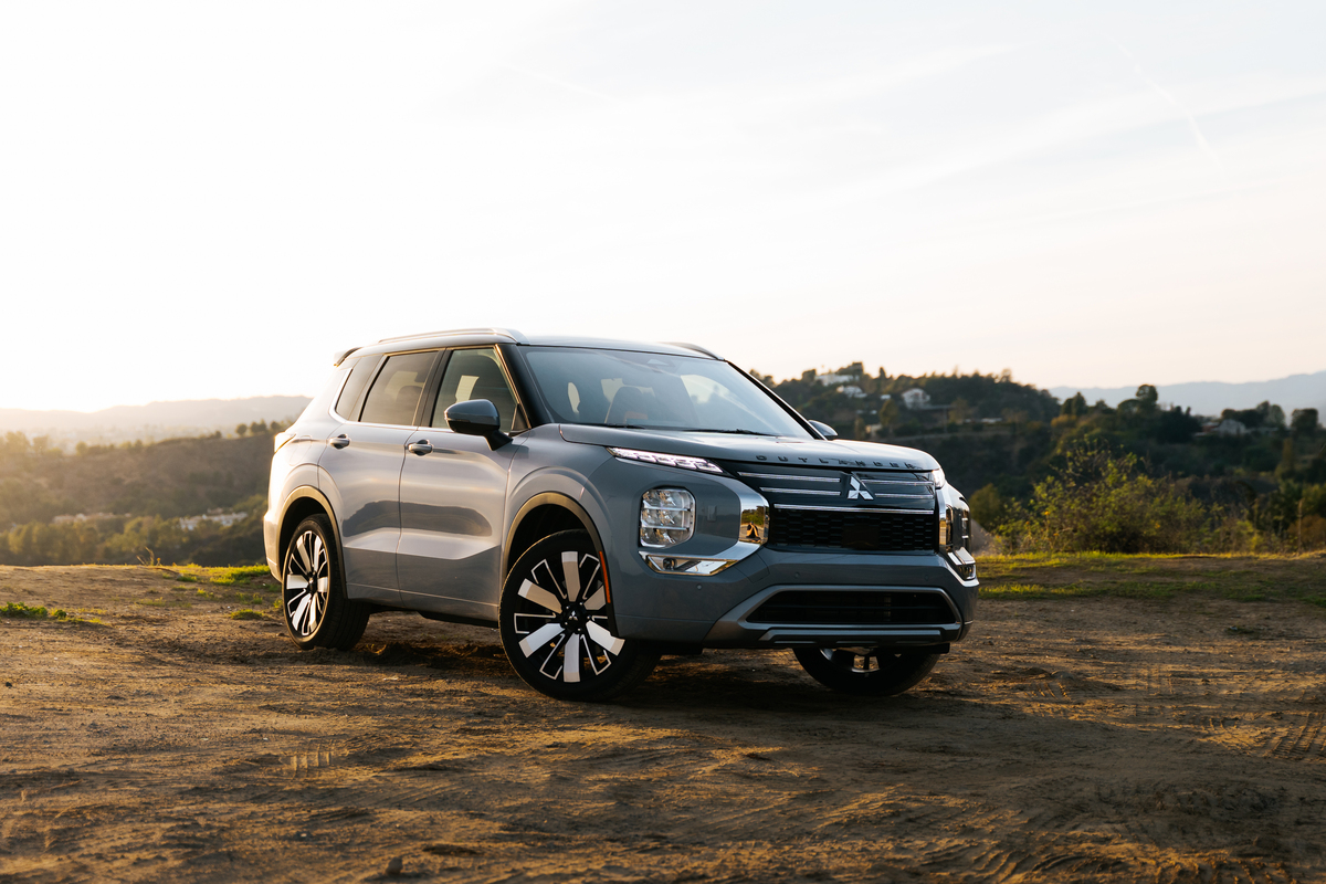 Silver Mitsubishi Outlander SUV parked on a dirt overlook at sunset for a Mitsubishi Outlander Review.