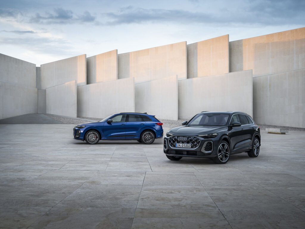 Two 2026 Audi Q5 SUVs parked in a modern concrete courtyard for an Audi Q5 Review.