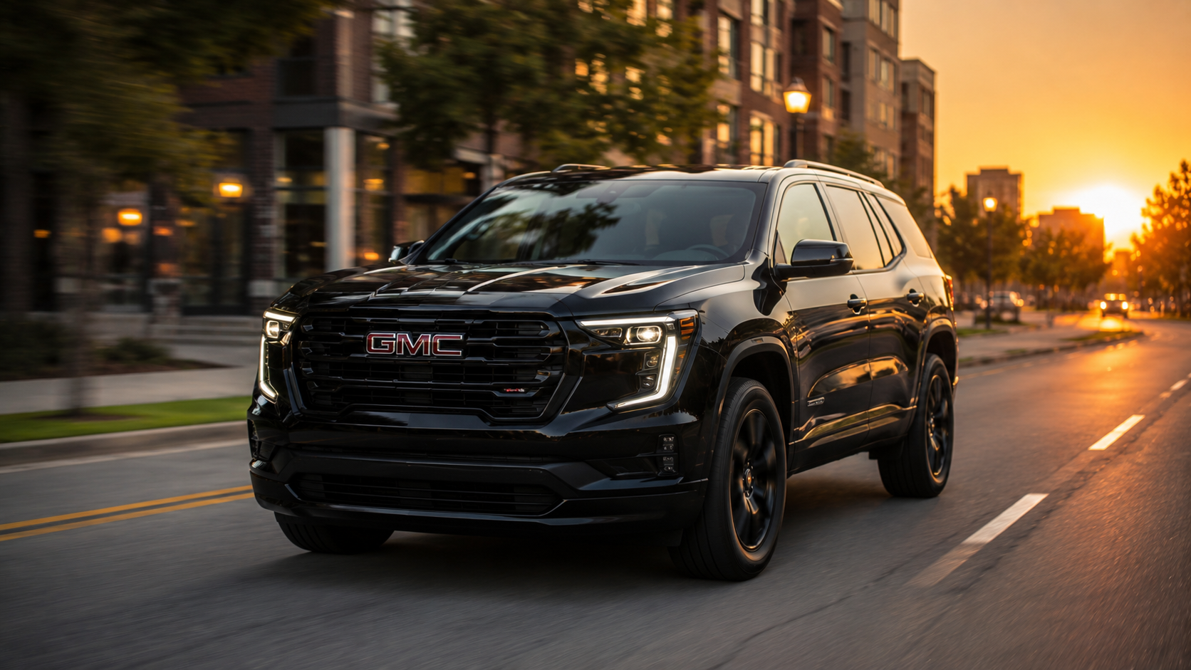 Black GMC SUV driving along a city street at sunset, warm orange sky and glowing streetlights in the background.