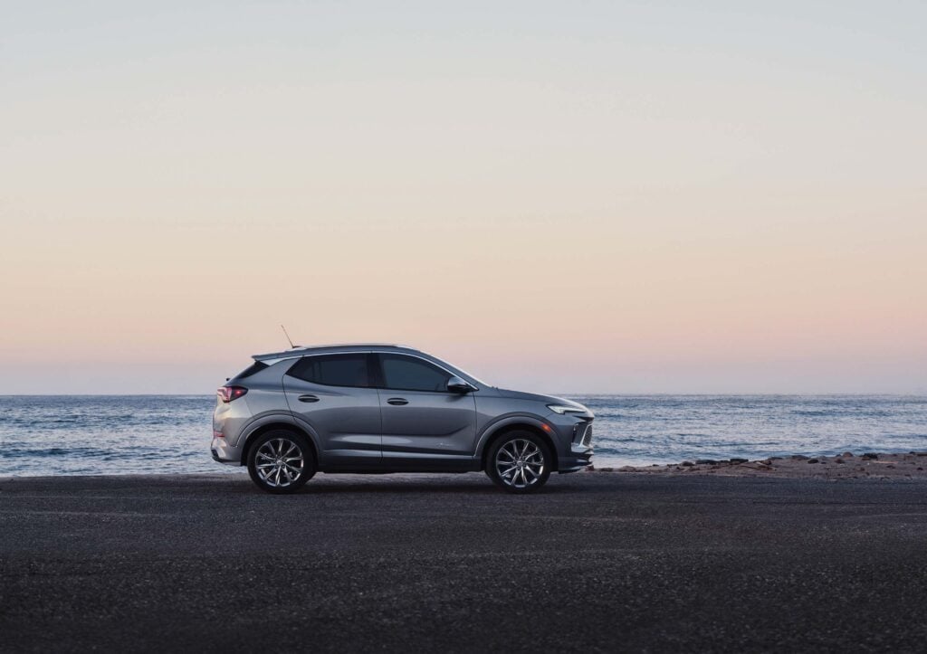 2026 Buick Encore GX in silver parked on a clean suburban street showcasing its sleek subcompact crossover profile