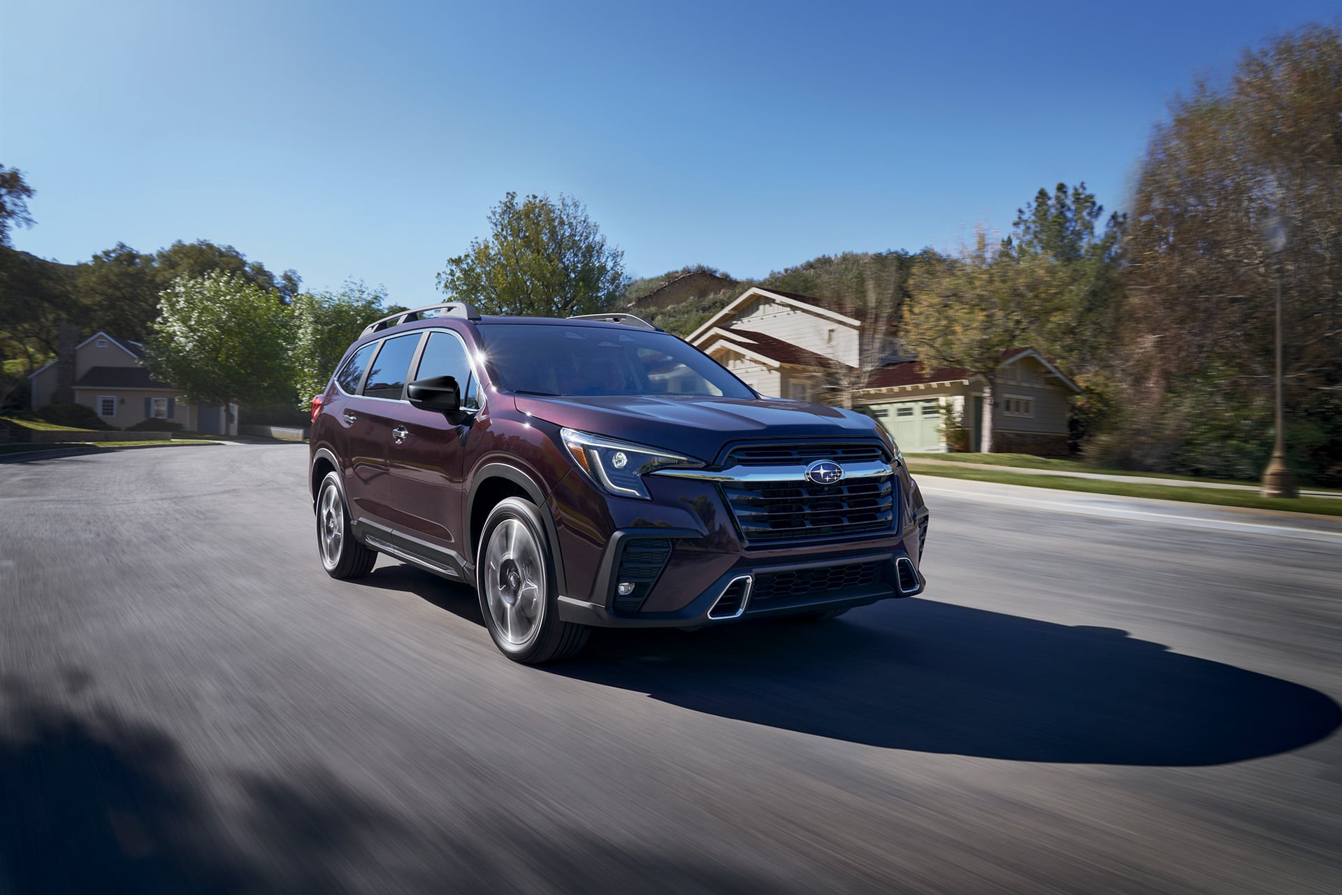 2026 Subaru Ascent Touring in Sapphire Blue Pearl parked on a mountain overlook with a forested valley in the background