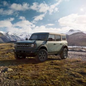Green Ford Bronco parked in a rugged mountain landscape, featured in our Ford Bronco Review.