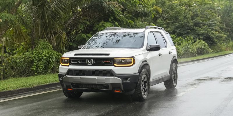 Honda Passport Review image of a white 2026 Honda Passport TrailSport on a wet road