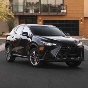 Black Lexus NX luxury SUV parked on a residential street in front of a modern home for a Lexus NX Review.