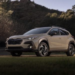 2026 Subaru Crosstrek parked on grass at sunset in front of a hill, featured in Subaru Crosstrek Review