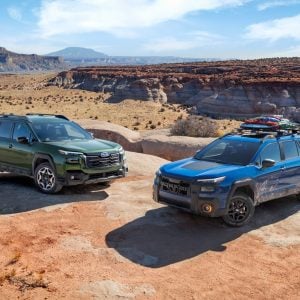 Subaru Outback Review 2026 shows two models tackling desert terrain with rugged styling and off-road readiness.