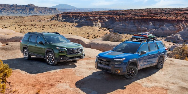 Subaru Outback Review 2026 shows two models tackling desert terrain with rugged styling and off-road readiness.