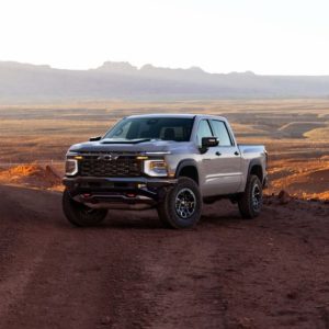 2027 Chevrolet Silverado 1500 off-road truck parked on a desert trail with mountains in the background