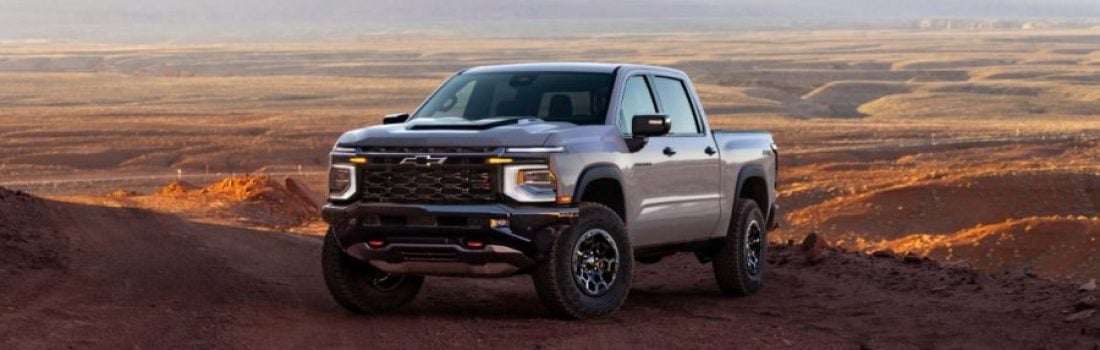 2027 Chevrolet Silverado 1500 off-road truck parked on a desert trail with mountains in the background