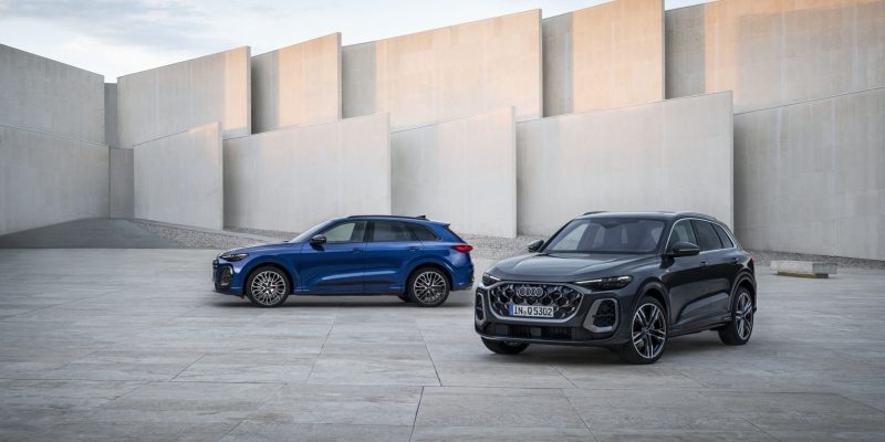 Two 2026 Audi Q5 SUVs parked in a modern concrete courtyard for an Audi Q5 Review.