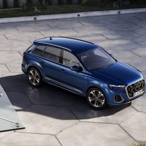 Blue Audi Q7 luxury SUV shown from an elevated angle in a modern courtyard for an Audi Q7 Review.