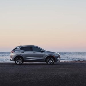 2026 Buick Encore GX in silver parked on a clean suburban street showcasing its sleek subcompact crossover profile