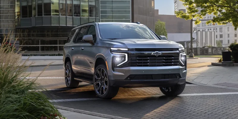 2026 Chevrolet Tahoe parked in an urban setting, showcasing its bold design and full-size SUV presence
