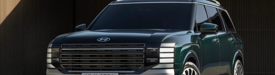2026 Hyundai Palisade parked in front of a modern building, featured in Hyundai Palisade Review