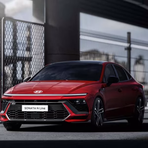 2026 Hyundai Sonata N Line in Abyss Black Pearl on a winding road, showcasing the sedan's aggressive front fascia and 19-inch alloy wheels