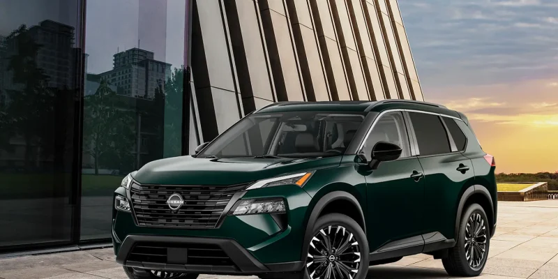 2026 Nissan Rogue compact SUV parked outdoors, showcasing modern design and bold front grille.