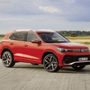 Red 2026 Volkswagen Tiguan SEL R-Line Turbo compact SUV shown from the front three-quarter angle on an open road.