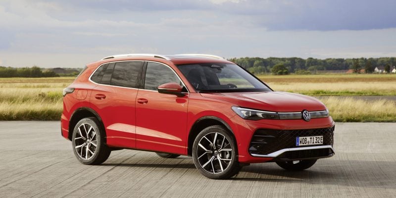 Red 2026 Volkswagen Tiguan SEL R-Line Turbo compact SUV shown from the front three-quarter angle on an open road.