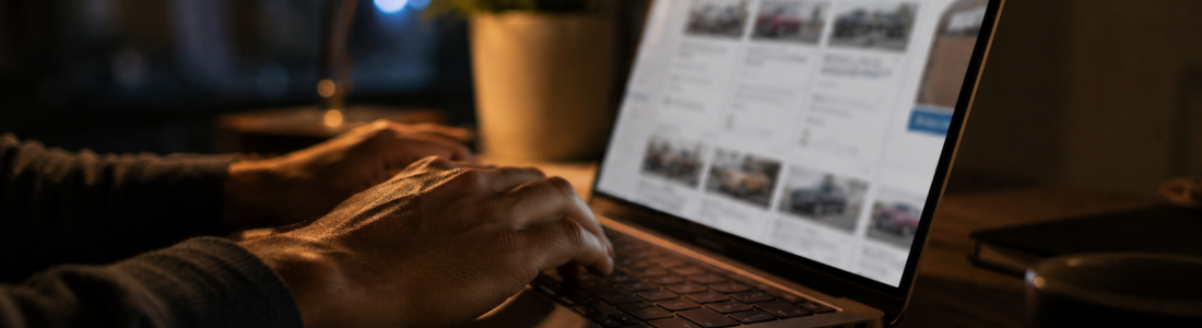 Shopper using the best website to find new car deals at night